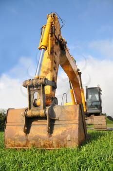 Huge excavator on a green field ready to work