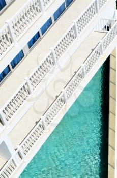 Resort floors with balconies looking down into a swimming pool