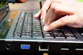 Female hands over a laptop keyboard
