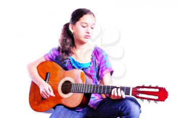 Young girl playing a guitar isolated on white