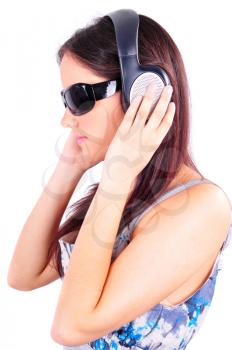 Profile of young girl with sun glasses listening to music on headphones isolated on white