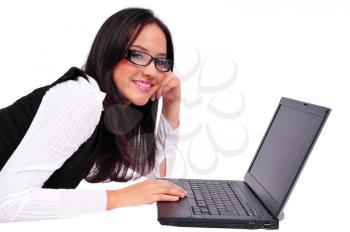 Young girl laying down and working on a laptop
