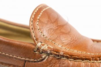 Macro shot of a brown shoe mocassin isolated on white
