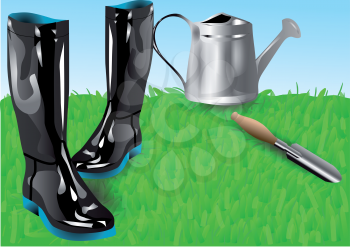 garden tools. boots with shovei on green grass