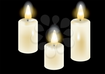 white candles. three candles isolated on a black background