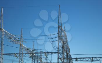 high voltage lines against the blue sky
