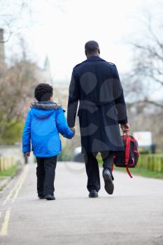 Father Walking Son To School Along Path
