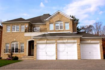 New detached single family luxury home with stone facade and tripple garage