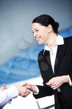 Photo of happy businesswoman handshaking after striking deal