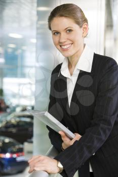 Photo of smart business lady touching balcony railing and looking at camera with smile