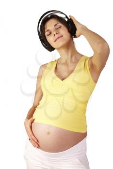 Photo of pretty pregnant woman wearing headphones and listening to music