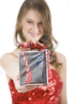Close-up of Christmas present in female�s hand being given by smart girl