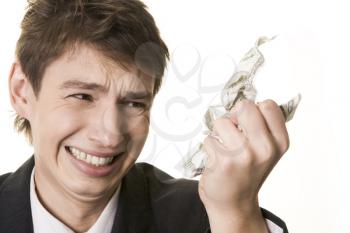 Anxious guy looking annoyingly at crumpled dollar note in his hand