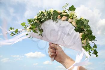 Photo of male hand holding a bridal bunch of flowers