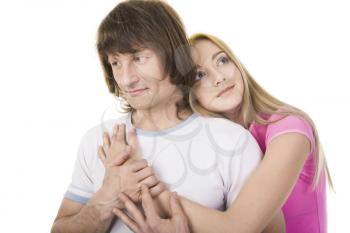 Portrait of attractive young girl embracing her boyfriend over white background