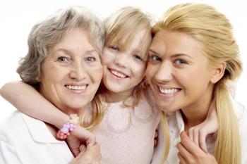 Photo of little girl clutching her grandmother and mother