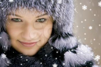 Image of beautiful female in luxurious fur head cloth looking at camera