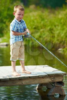 Photo of little kid fishing on weekend