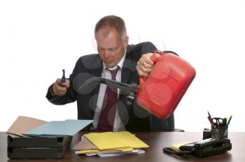 Businessman about to set fire to a pile of documents.