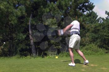 Golfer taking a tee shot with motion blur