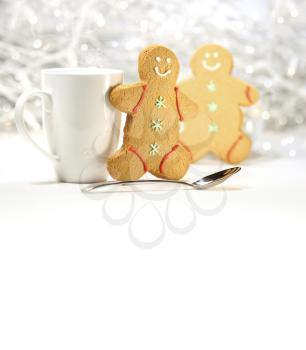 Royalty Free Photo of a Cup, Spoon and Two Gingerbread Men