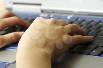 A working businesswoman with hands typing on her laptop