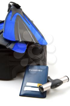 A shot of a luggage, a passport and a pair of flippers, can be used for travel or vacation concept