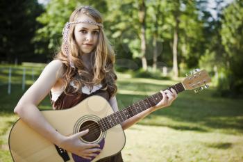 A portrait of a caucasian girl with her guitar
