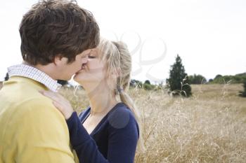 A young caucasian couple in love kissing outdoor 