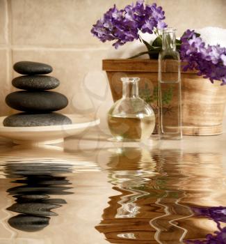 day spa products with stones, oil container, flowers