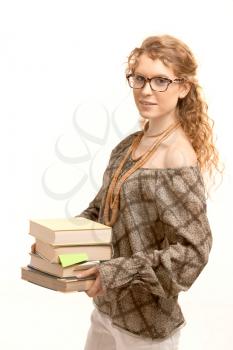 Pretty girl wearing glasses with books, studying for exame.