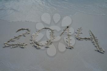 2014 year written on the sand beach