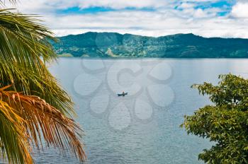 Fisherman on Lake Toba, Sumatra, Indonesia, Southeast Asia.  It is the largest and deepest volcanic crater lake in the world.