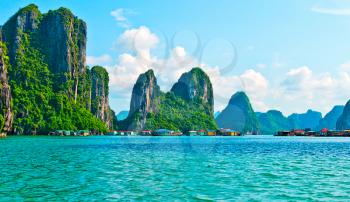 View of floating village and rock islands in Halong Bay, Vietnam, Southeast Asia