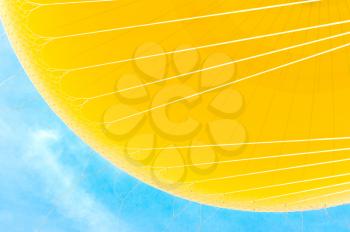 Close up of yellow hot air balloon on blue sky background