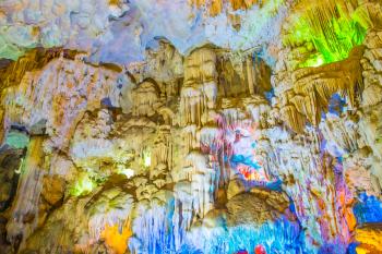 Famous cave in Halong bay illuminated by colorful lights, Vietnam, Southeast Asia