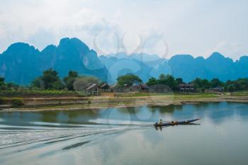 River, boat, village and mountains landscape, Laos, Southeast Asia