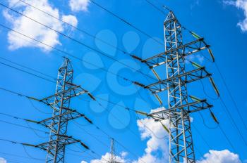 Power line tower on blue sky background