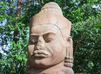 Ancient stone face near Bayon Temple, Angkor Wat complex, Siem Reap, Cambodia. UNESCO World Heritage Site.