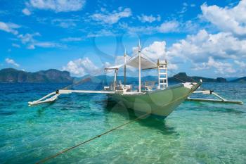 Traditional wooden boat in clear sea water, El Nido, Palawan, Philippines