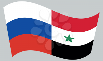 Russian and Syrian flags waving on gray background