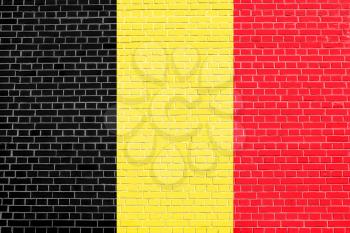 Flag of Belgium on brick wall texture background. Belgian national flag.