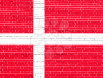 Flag of Denmark on brick wall texture background. Danish national flag.