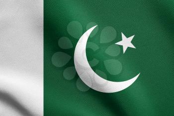 Flag of Pakistan waving in the wind with detailed fabric texture. Pakistani national flag.