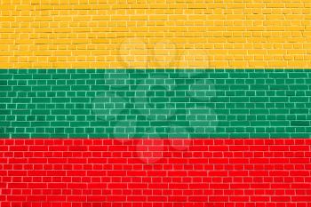 Flag of Lithuania on brick wall texture background. Lithuanian national flag.