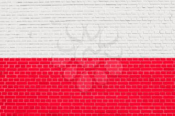 Flag of Poland on brick wall texture background. Polish national flag.