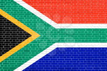 Flag of South Africa on brick wall texture background. South African national flag.