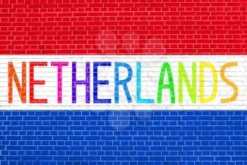 Flag of the Netherlands on brick wall texture background. Multicolored word Netherlands.