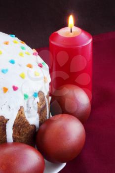 Easter cake with eggs and burning candle