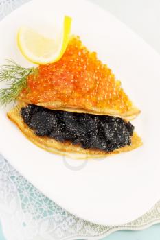 thin pancakes with red and black caviar